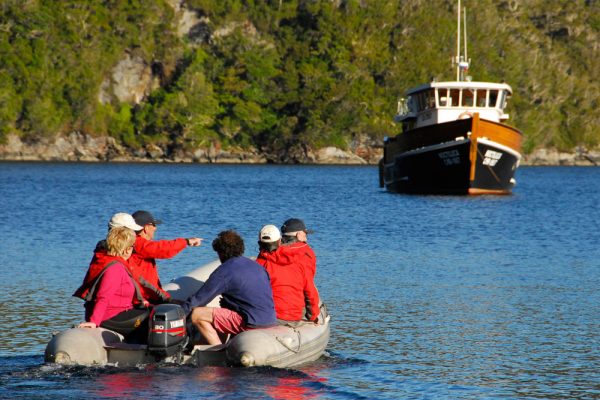 A group of people on a tender traveling to their expedition yacht in Chile