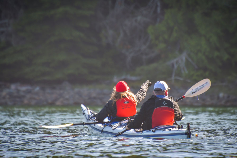 Guests paddling twin kayak