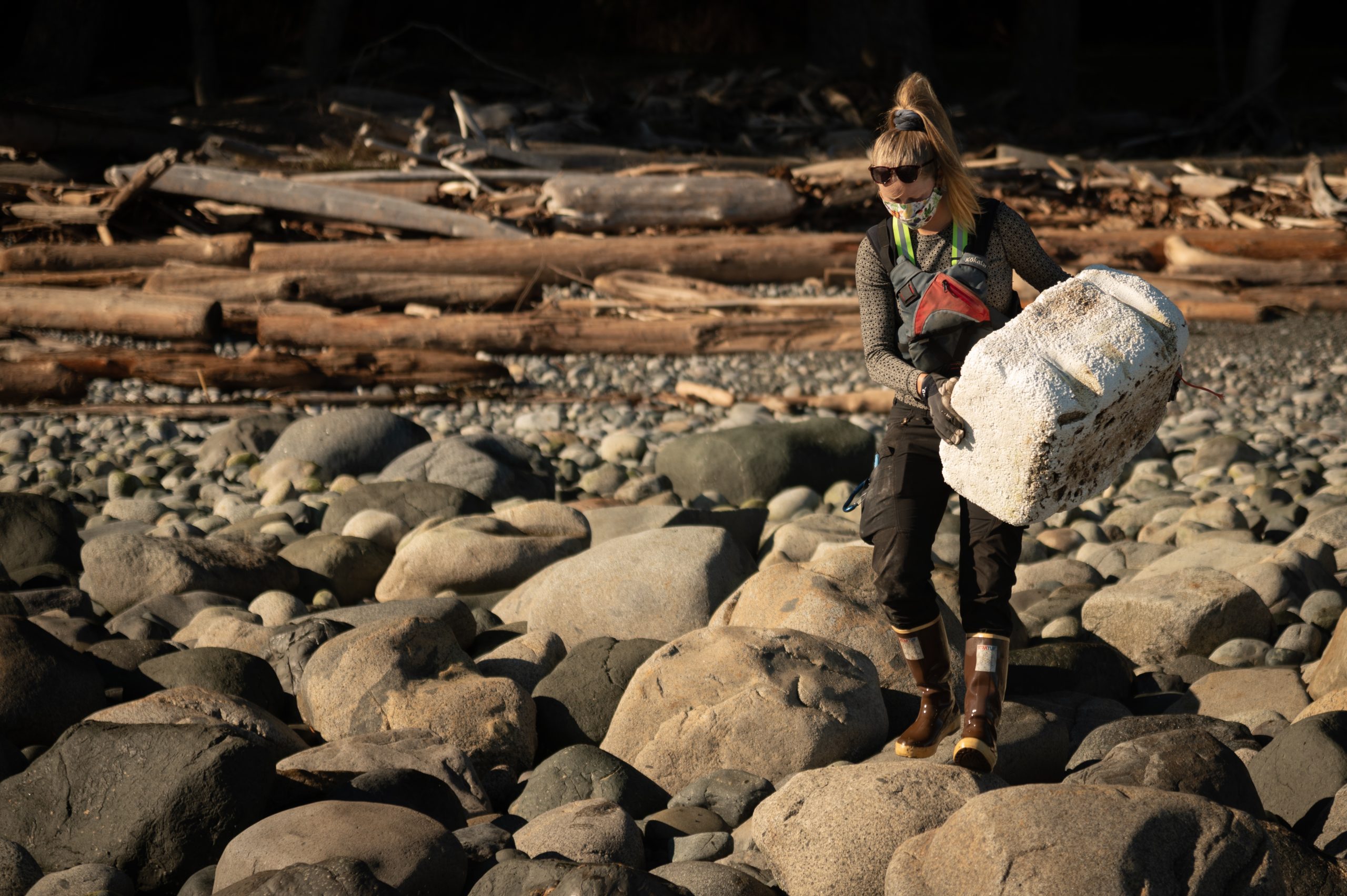 Woman picking up island debris