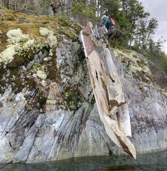 Derelict boat hanging from a cliff on Quadra Island