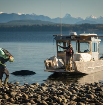 Moving Debris to Boat with Desolation Sound in the background