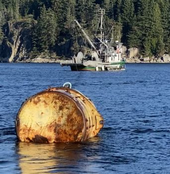 Large steel mooring float getting towed