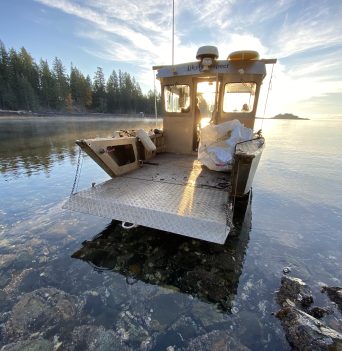 Marine debris pick up boat in morning sun