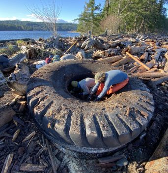 Crew cleaning out excavator tire