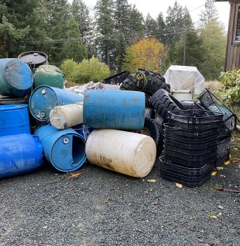 Pile of barrels and other marine debris at Quadra Island operations base