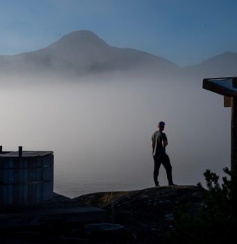 Guest standing by hot tub in fog