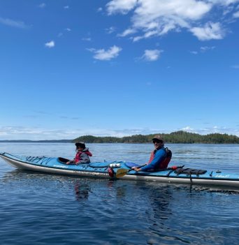 A father and child kayaking in the Johnstone Strait