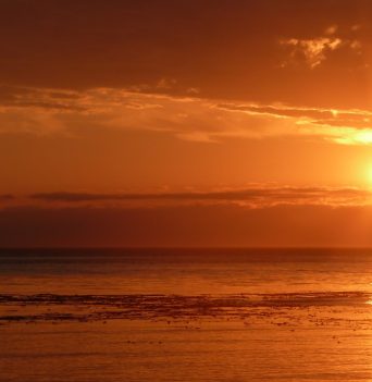 A bright orange sunset in the Johnstone Strait