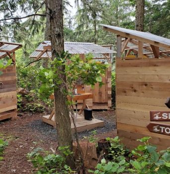 Outdoor bathrooms at a kayaking camp