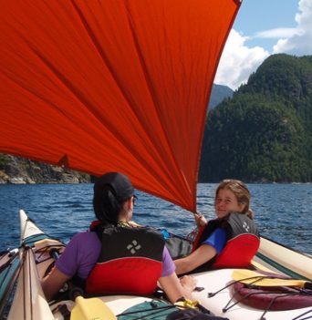 Kids setting up a sail while kayaking in the Johnstone Strait