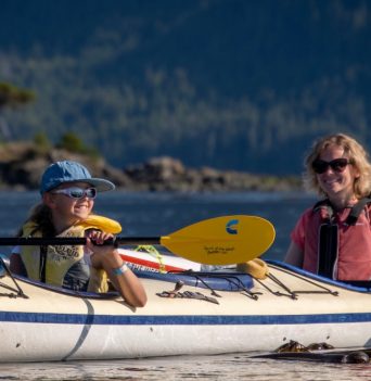 A mom and daughter kayaking in the Johnstone Strait