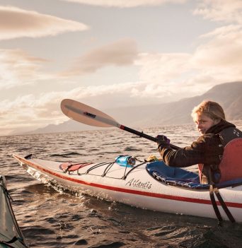 A young kayaker paddling in the Johnstone Strait