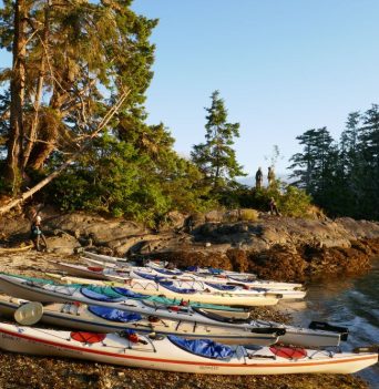 Sea Kayaks docked in rocky cove