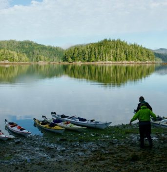 Kayakers carrying kayak to the water