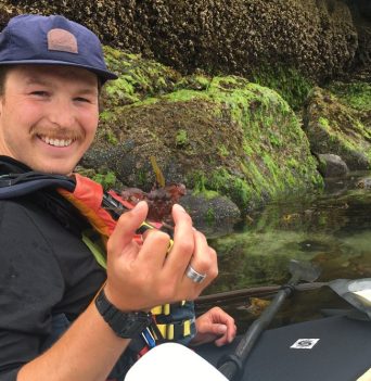 Kayaker holding small crab