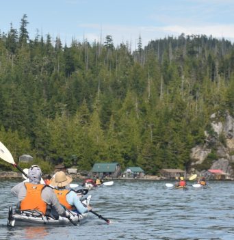 Twin kayakers paddling to shore