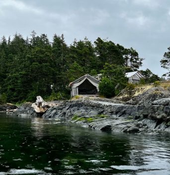 The rocky bluffs of the Johnstone Strait Ultimate basecamp from the water