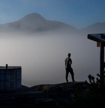 Guest looking over the sea layer from Johnstone straight basecamp