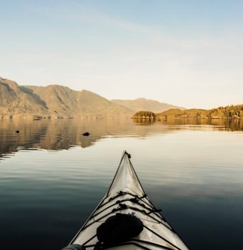 Close-up of sea kayak on water looking out at scenic views