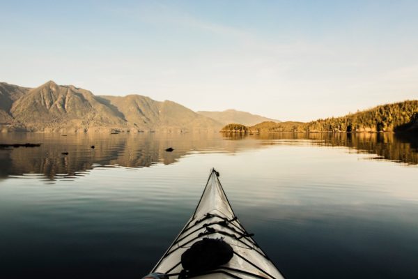 Close-up of sea kayak on water looking out at scenic views
