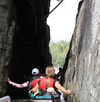 Sea kayaker navigating narrow passage
