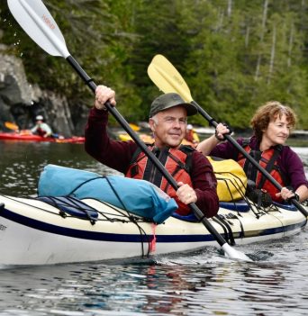 Kayak group paddling along BC coast