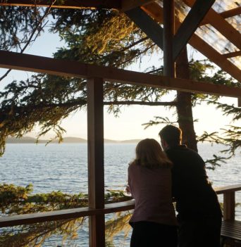 Two guests enjoying the view from dining area of glamping site