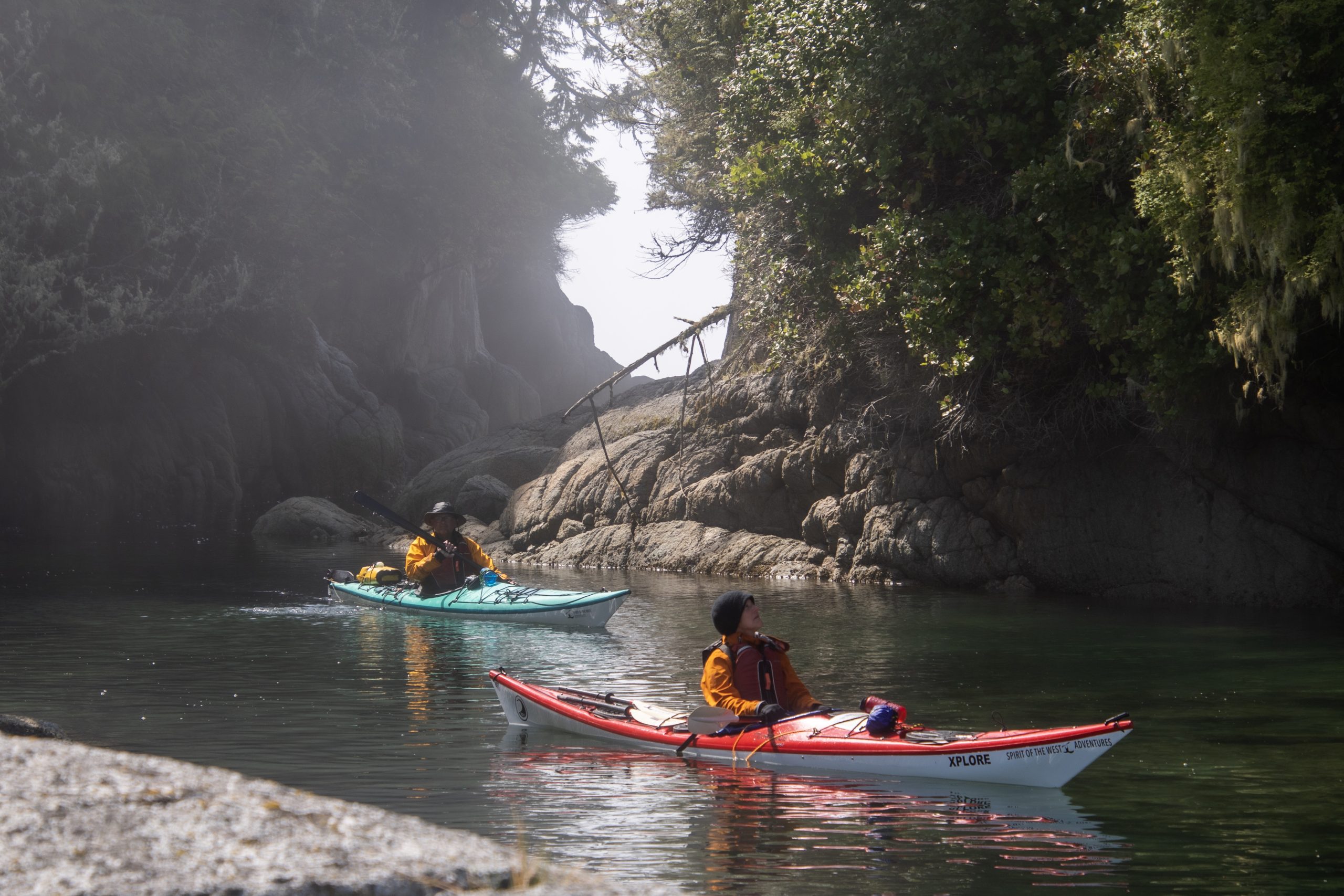 Two Kayakers Paddle through Rocky Inlet in Coastal BC