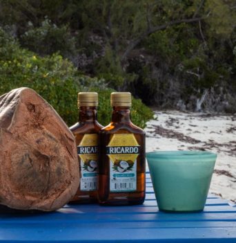 A coconut rum drink on a blue table in the Bahamas