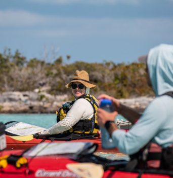 Two kayakers paddling on the ocean