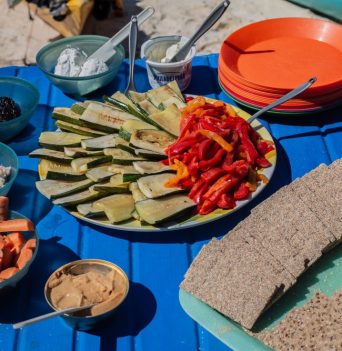 A platter of sandwich ingredients at a picnic