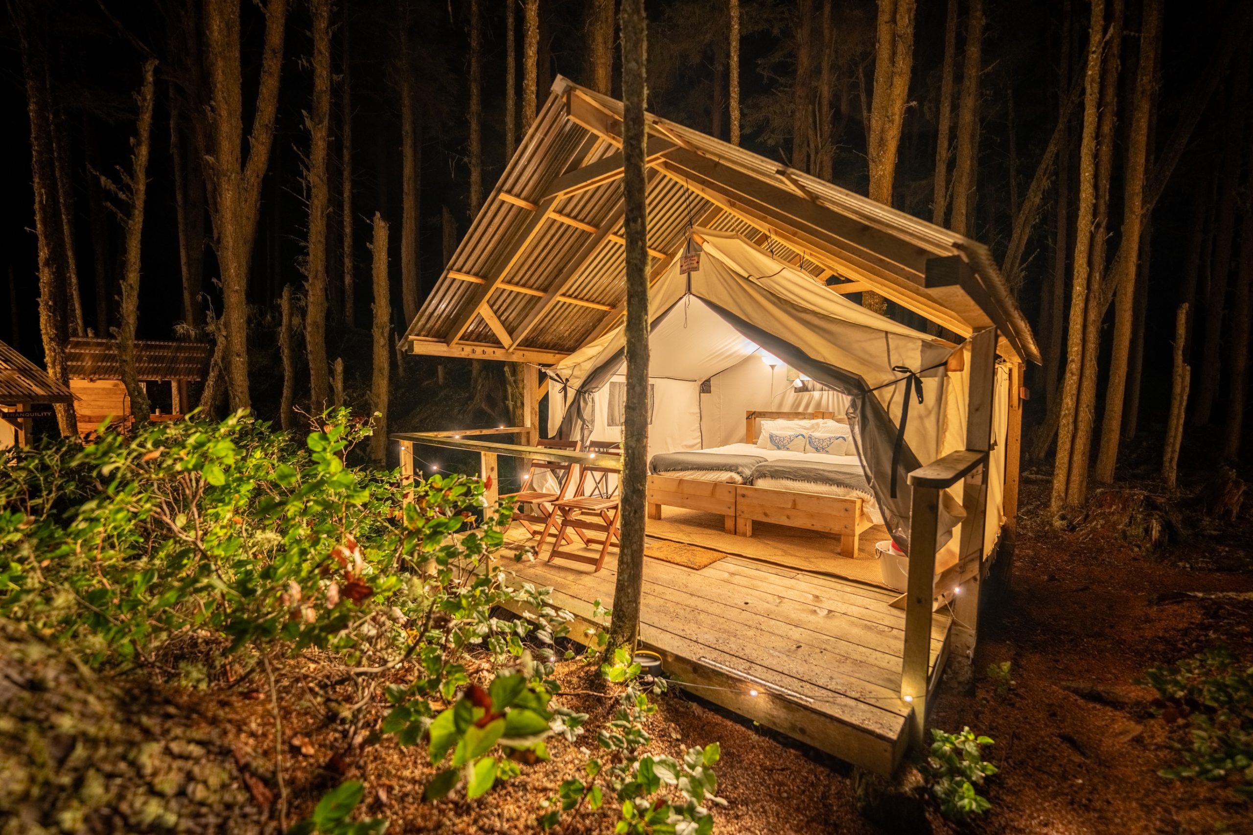 Large glamping tent lit up at night