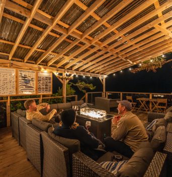 Guests hanging out in an outdoor lounge at night