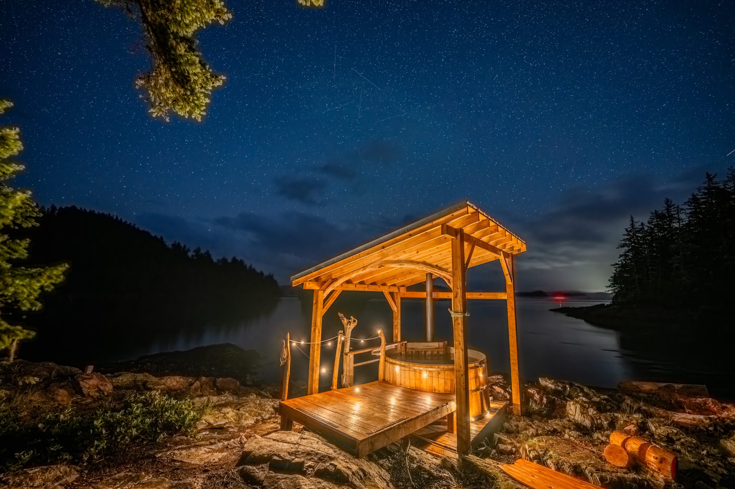 Outdoor hot tub at night with lights