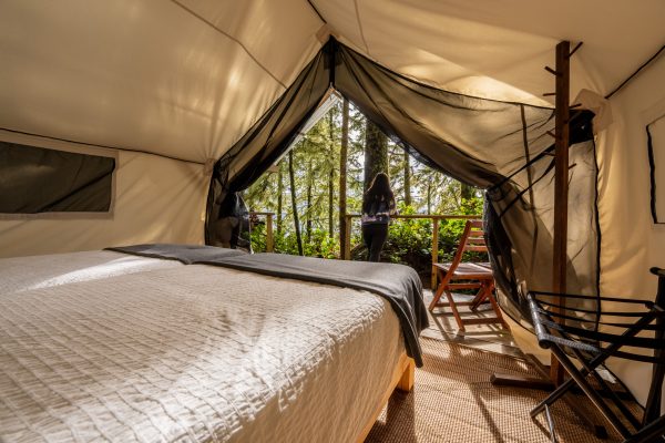 Interior of a large glamping tent in the woods