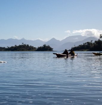 A group of kayakers paddling in Chile