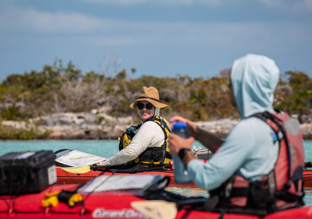 Two kayakers paddling on the ocean