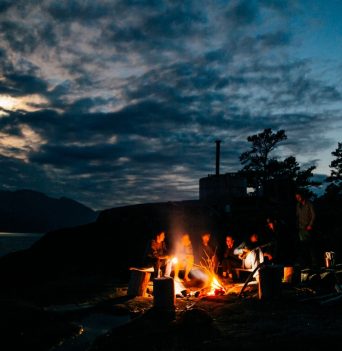 A group of people having a beach fire in BC