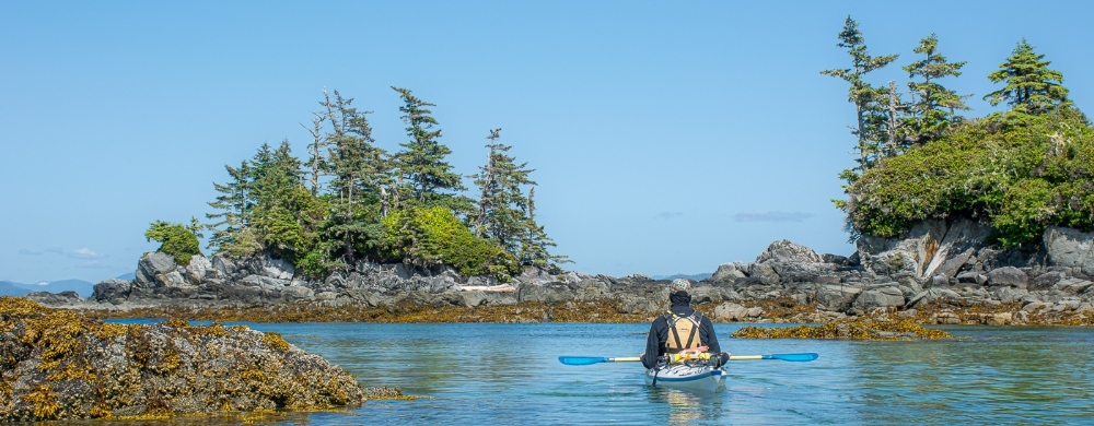 Kayaker resting in the ocean off the coast of the Great Bear Rainforest
