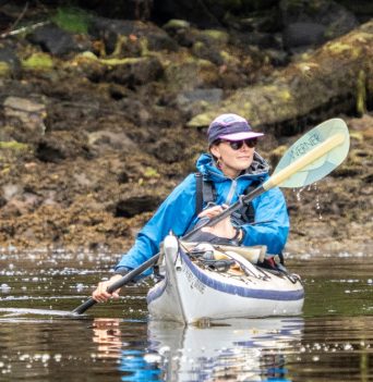 A kayaker paddling in the Great Bear Rainforest