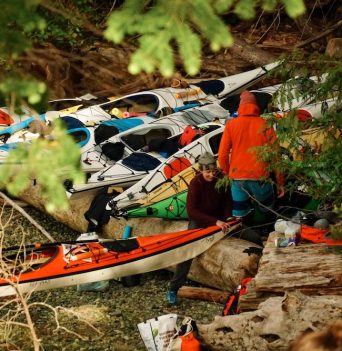 Two people packing colourful kayaks in the Desolation Sound