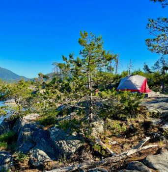 A tent upon a platform at one of Desolation Sound's rocky campsites
