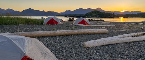 Three tents on a rocky beach in the Nuchatlitz region