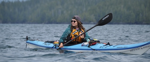 Guide paddling through the waters of Coastal BC