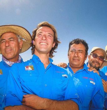 A group of camp guides standing on the beach