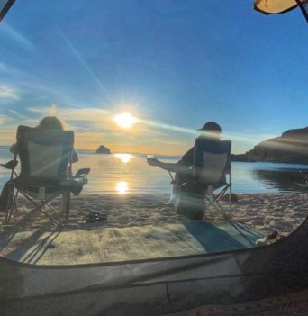Two people lounging in beach chairs in Baja Mexico