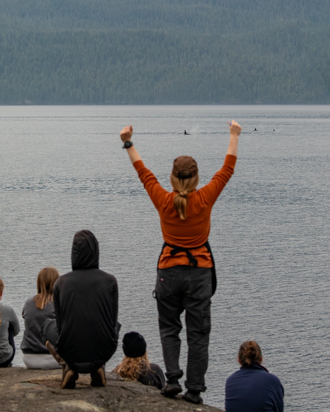 Kayaking guest with arms raised